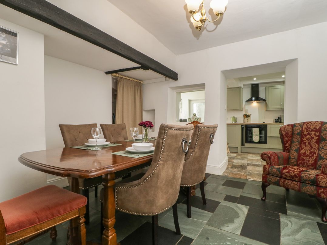 A dining room with a table and chairs at Fountain Cottage in Keswick