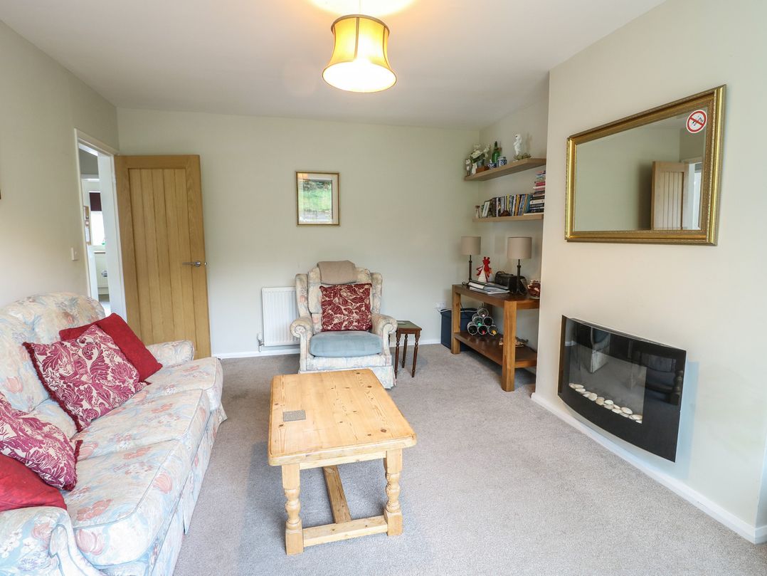 A living room with a sofa and coffee table at Awelon in Rhos-On-Sea