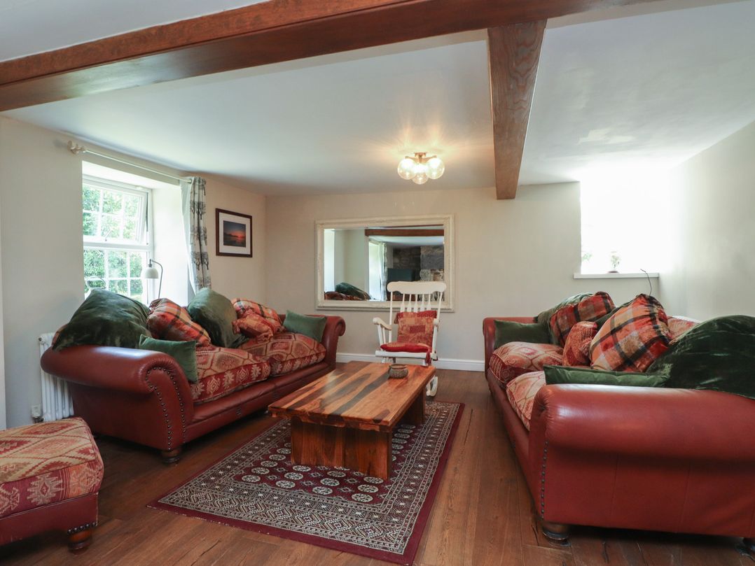 A living room with sofas and a coffee table at Plas Mawr in Groeslon