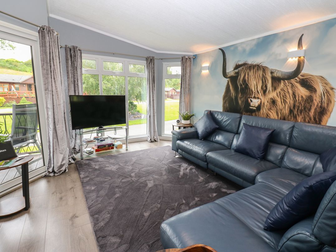 A living room with a sofa and television at 16 Badgers Retreat in Richmond