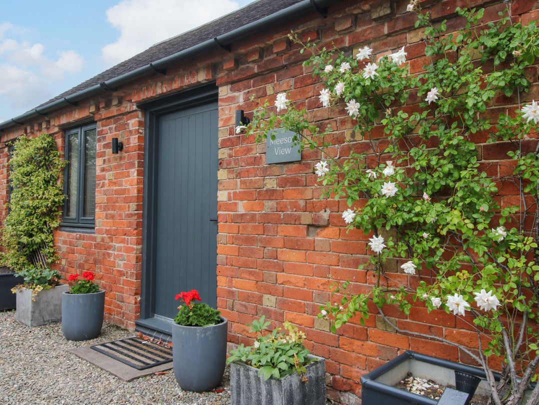 A doorway with flower pots at Meeson View in Meeson near Waters Upton