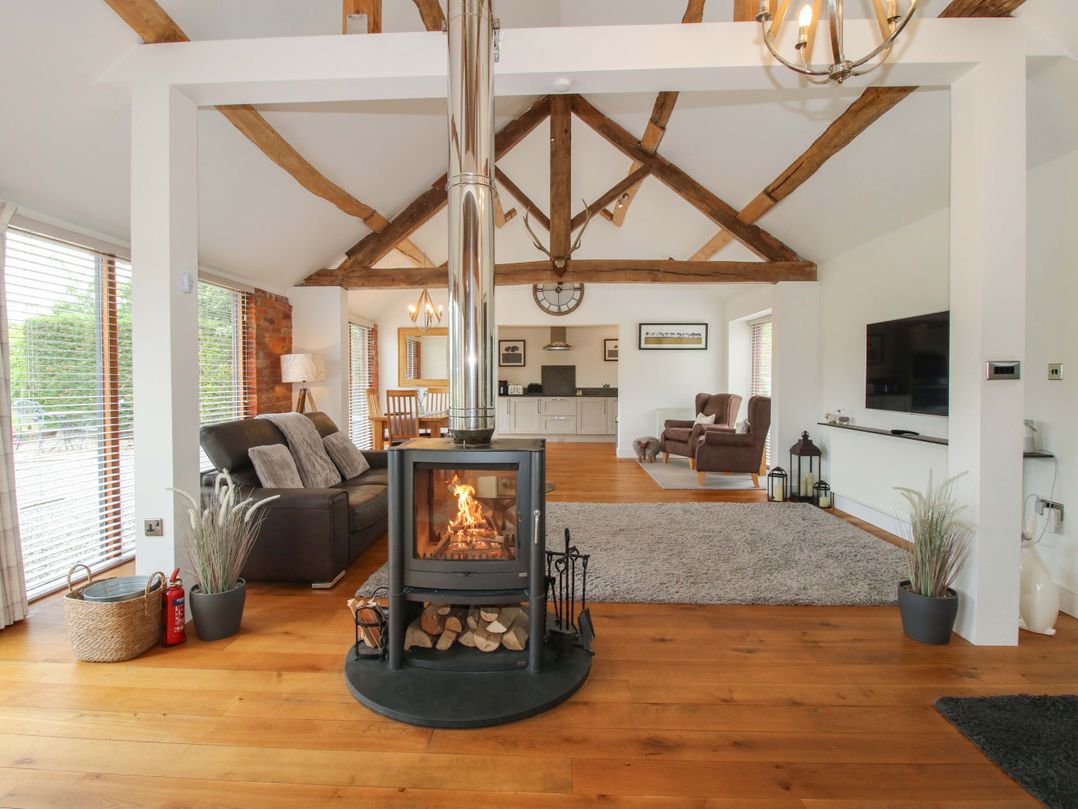 A living room with a fireplace and sofa at Meeson View in Meeson near Waters Upton