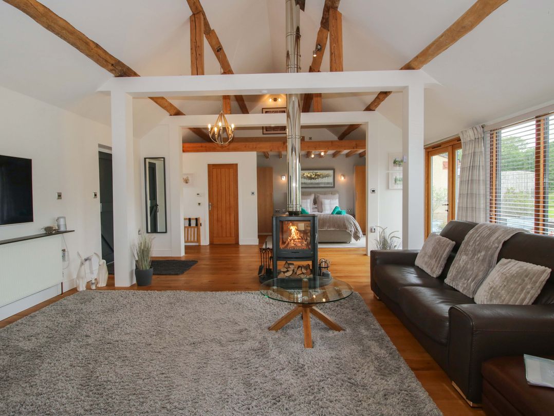A living room with a fireplace and sofa at Meeson View Meeson near Waters Upton