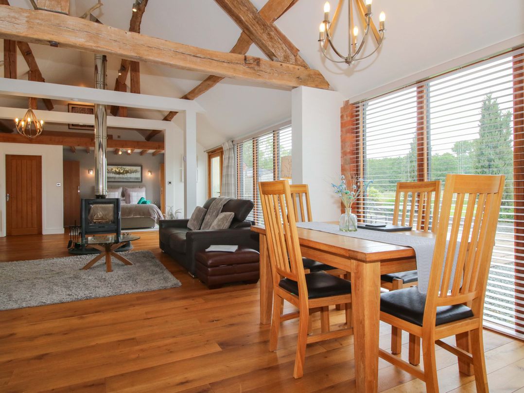 A living room with a sofa and dining table at Meeson View in Meeson near Waters Upton