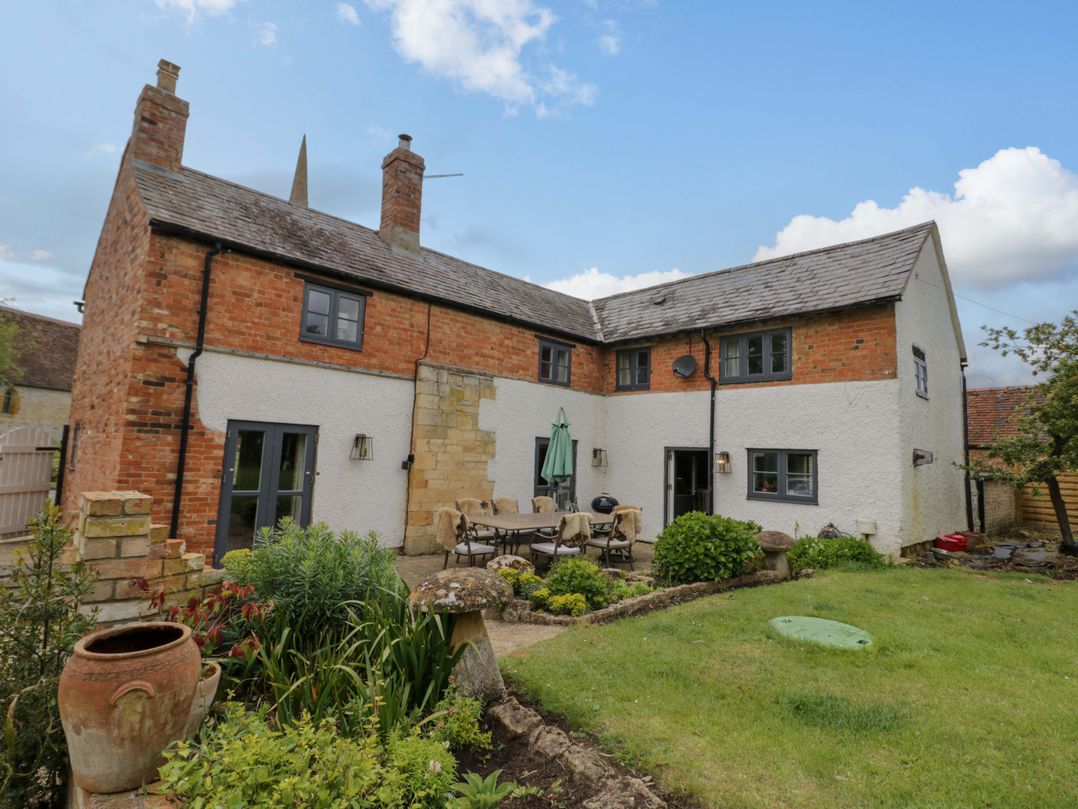 A house with garden furniture and plants at Elmhurst Cottage in Lower Quinton