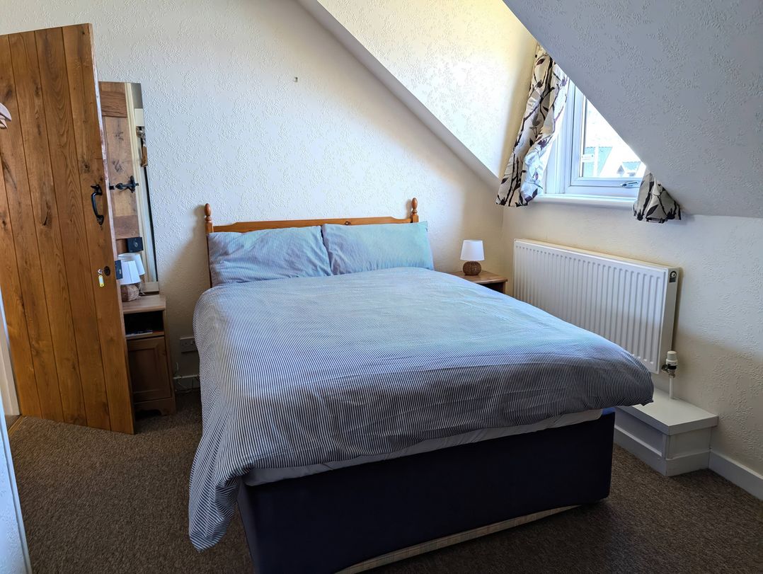 A bedroom with a bed and bedside table at Callart View in Glencoe