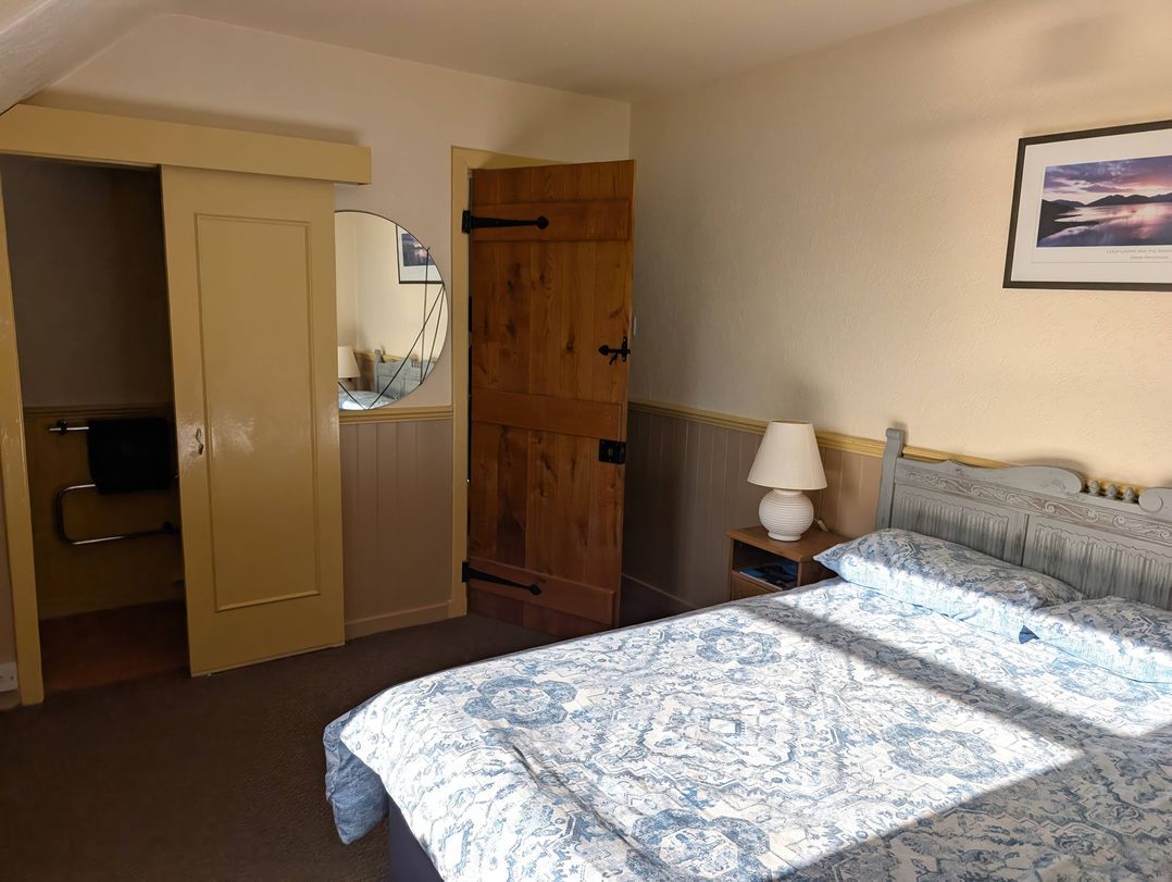 A bedroom with a bed and nightstand at Callart View in Glencoe