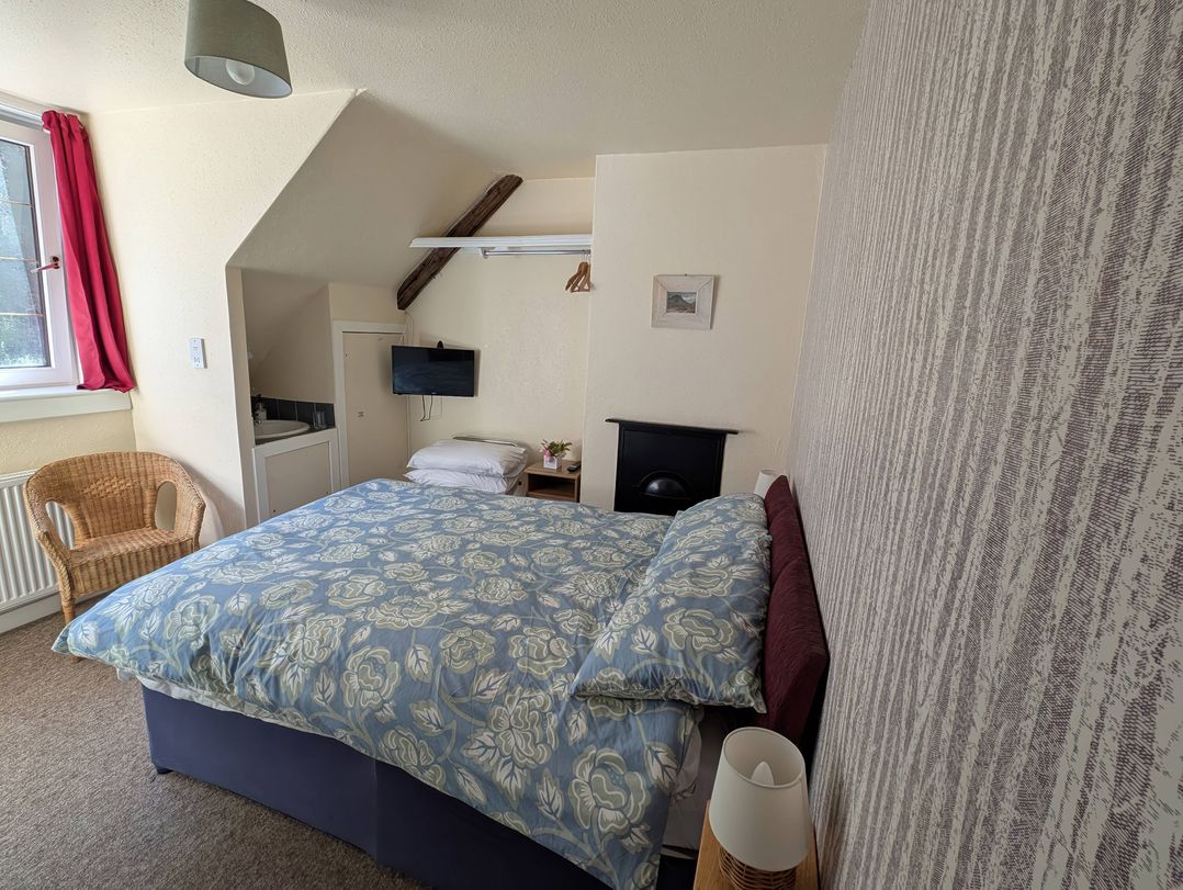 A bedroom with a bed and television at Callart View Glencoe