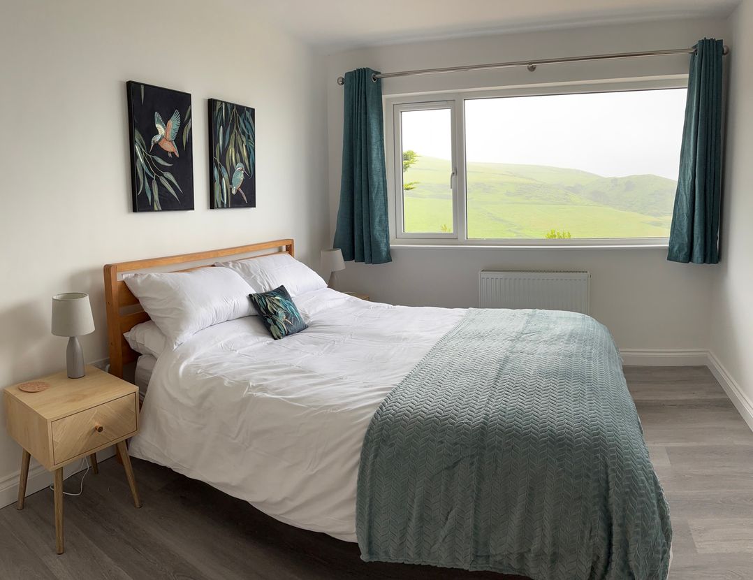 A bedroom with bed and window view at Belvedere in Woolacombe