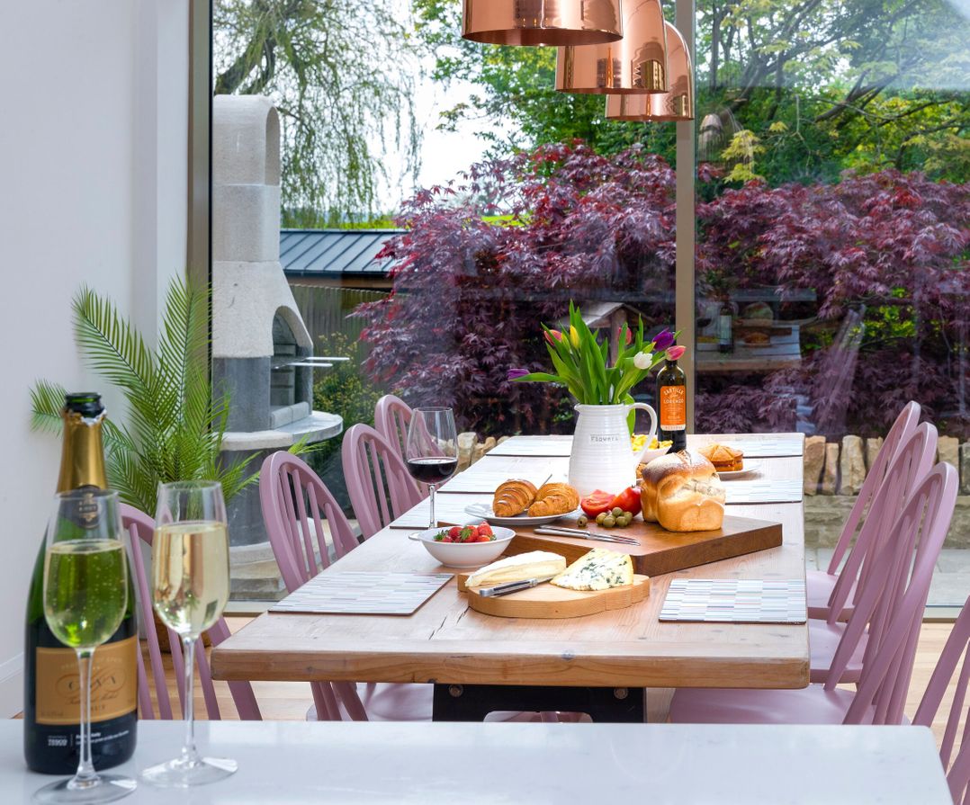A dining room with a table set for a meal at 2 The Croft in Skipton
