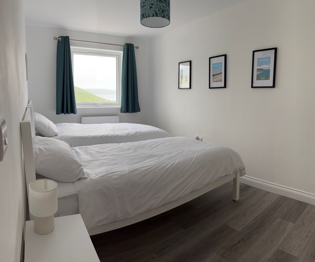 A bedroom with two beds and a window at Belvedere in Woolacombe