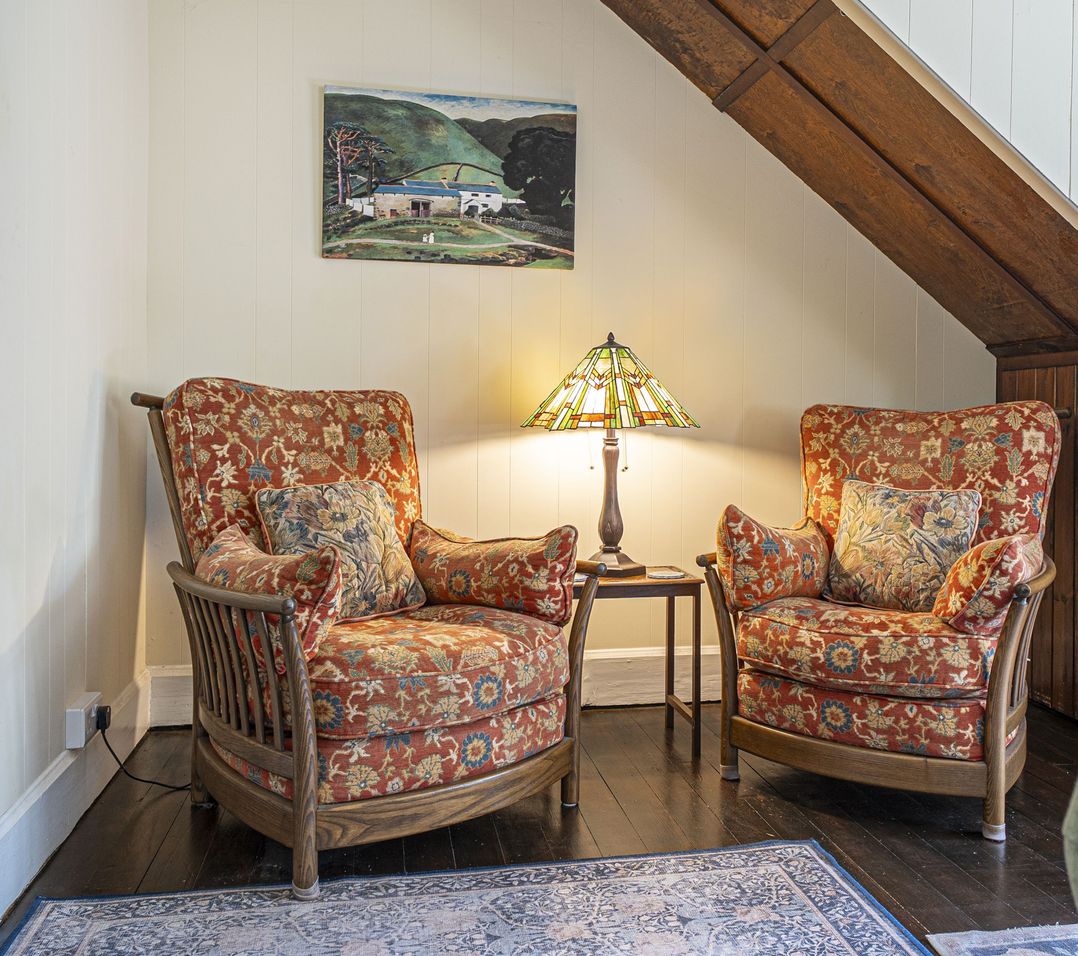 A sitting room with two armchairs and a lamp at Primrose Spinney Highwood near Ringwood