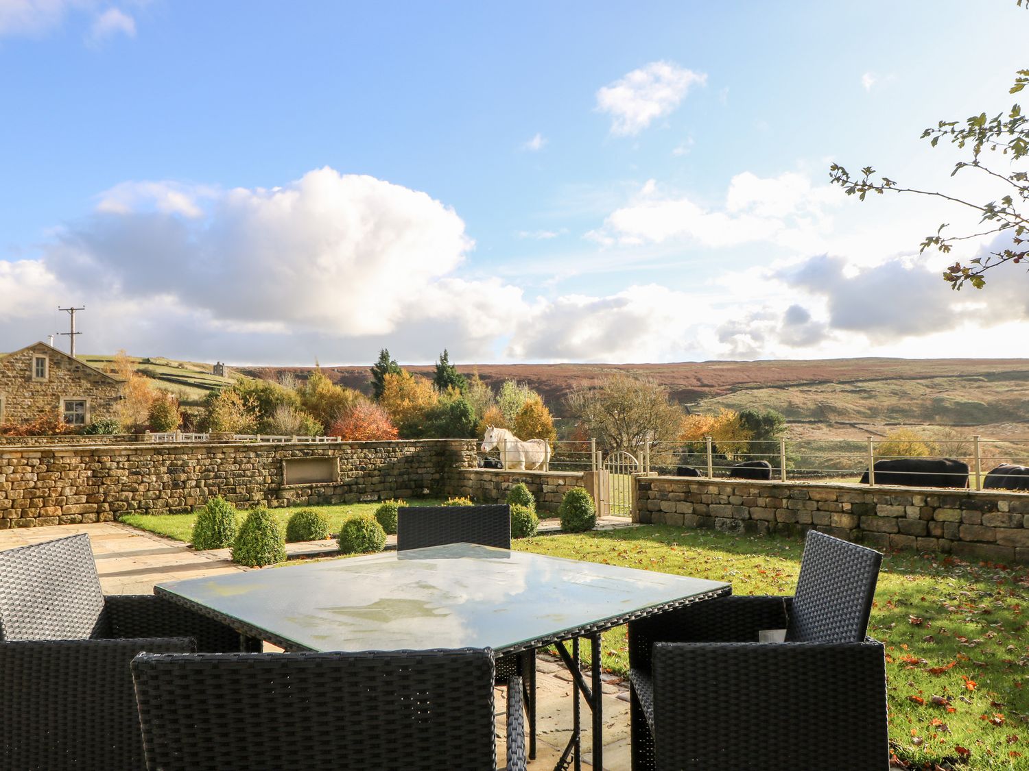 Patio area Kitchen area with breakfast bar at The Old Shippon Cowling ( Ref 1017543 ) Holiday cottage at The Old Shippon Cottages Cowling North Yorkshire