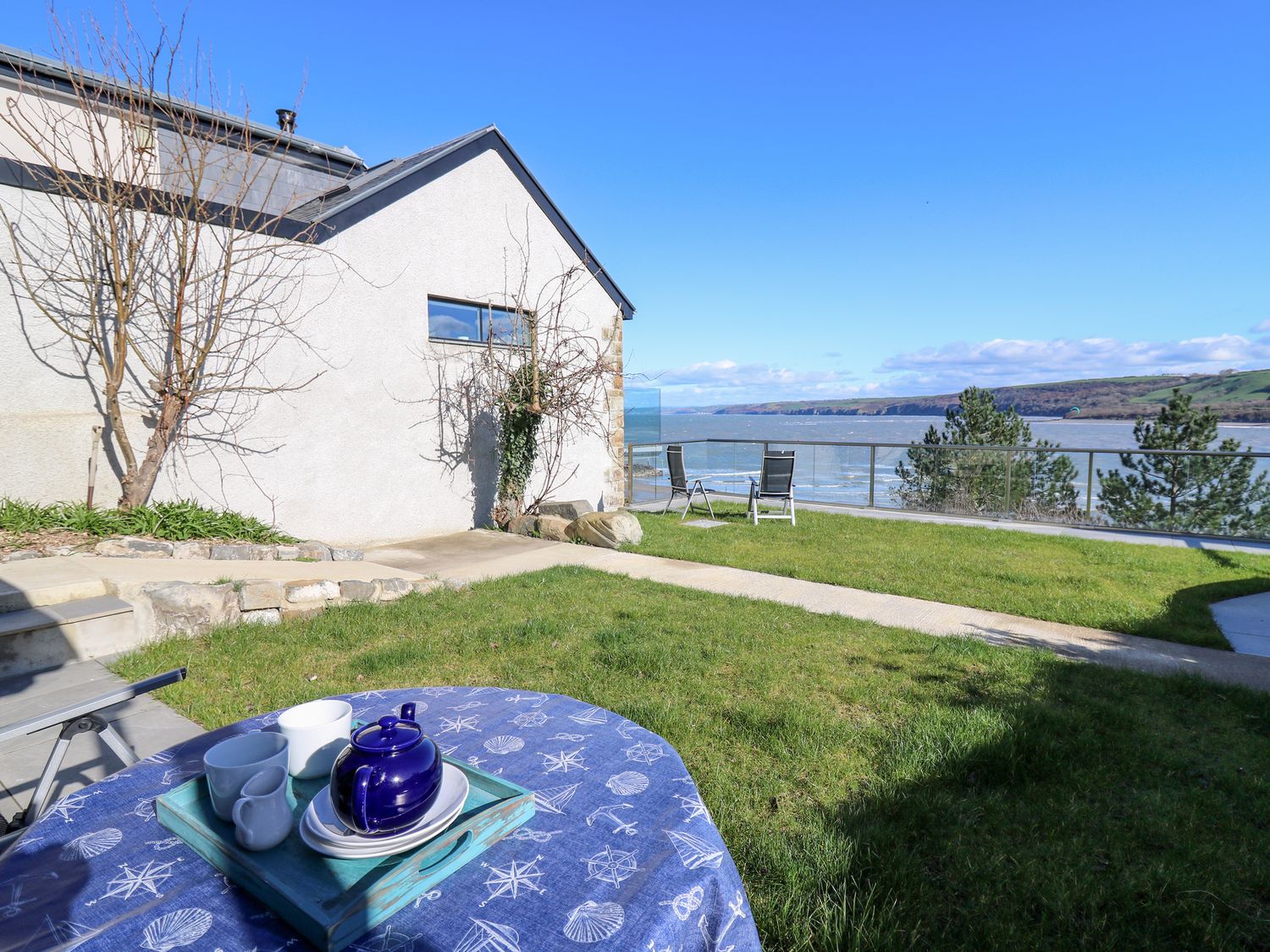 Fronwig is located in New Quay, Ceredigion. Four-bedroom home with sea views and wood-fired hot tub.