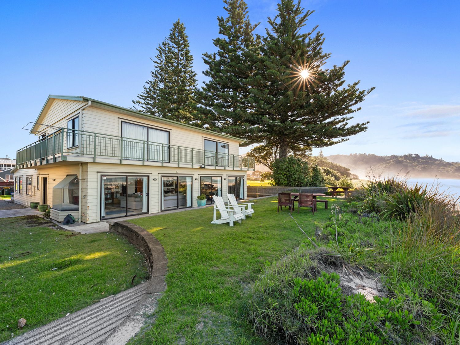 A house with a deck and balcony in an outdoor area at Beach Galore - Waihi Beach