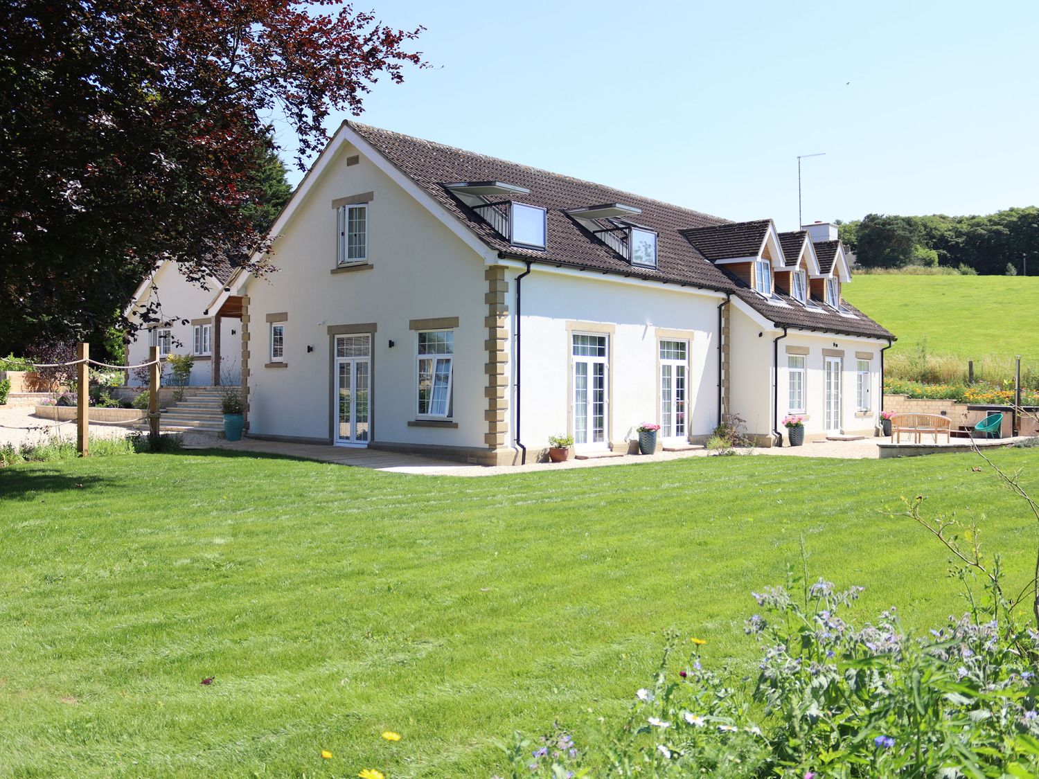 Leafield House in Upper Seagry, Wiltshire. Hot tub. Cinema room. Library. Freestanding bath. Luxury.