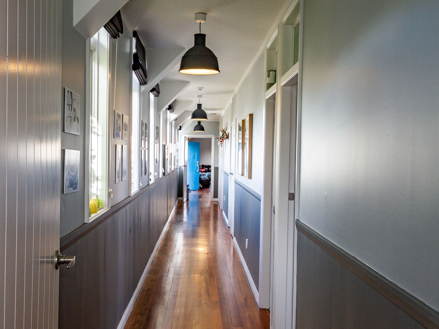 A long hallway with wooden floor and windows on the left side at Ohakune Barracks Ohakune