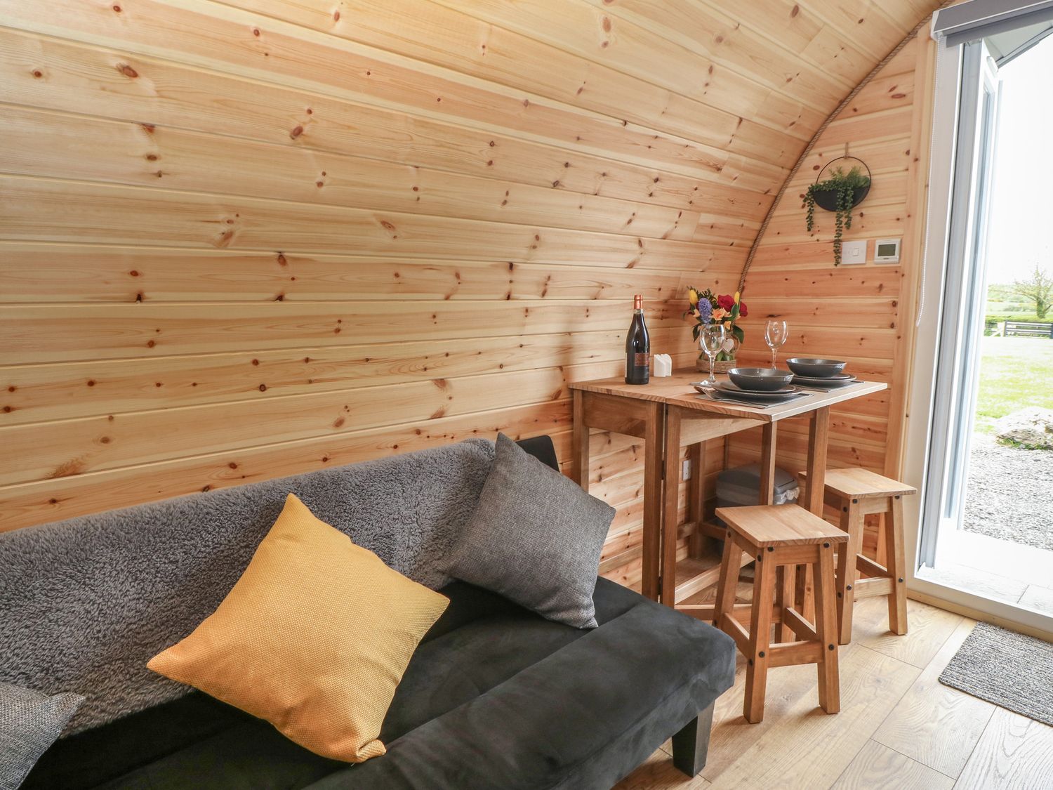 Parys Pod by Amlwch, Anglesey. Studio-style open-plan living, sofa bed, patio, hot tub, rural views.