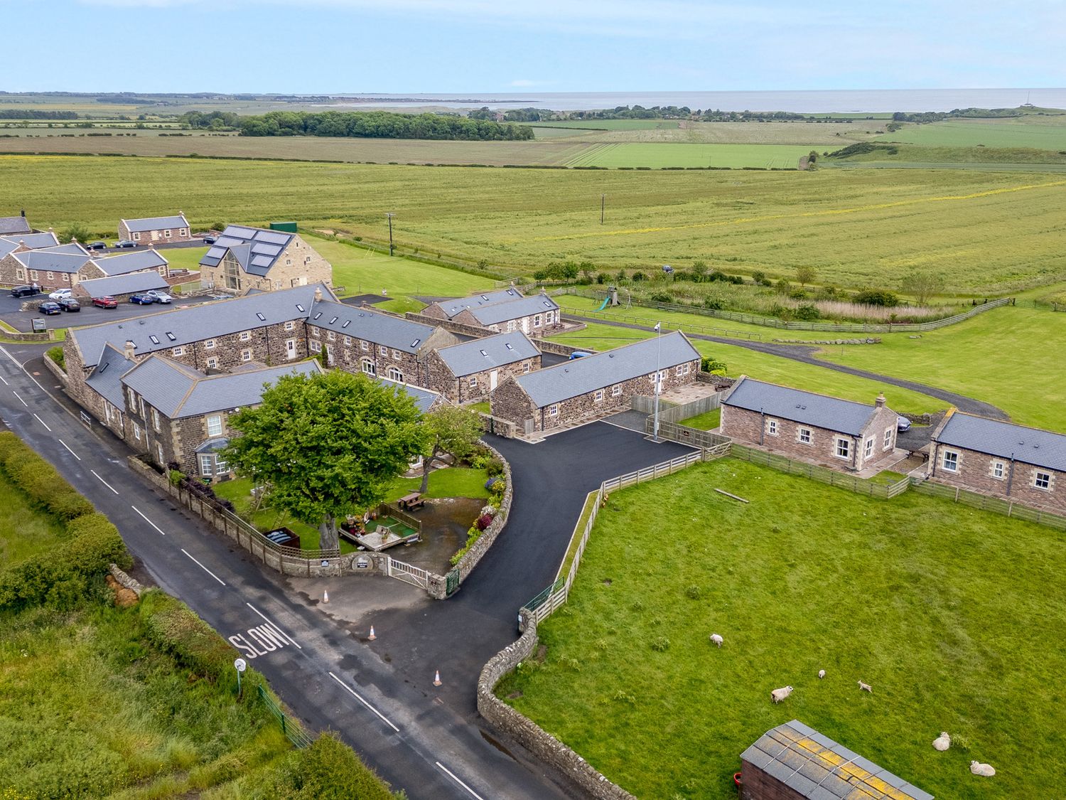 Byre Cottage in Embleton, Northumberland. Single-storey. Child-friendly. Spacious patio with hot tub