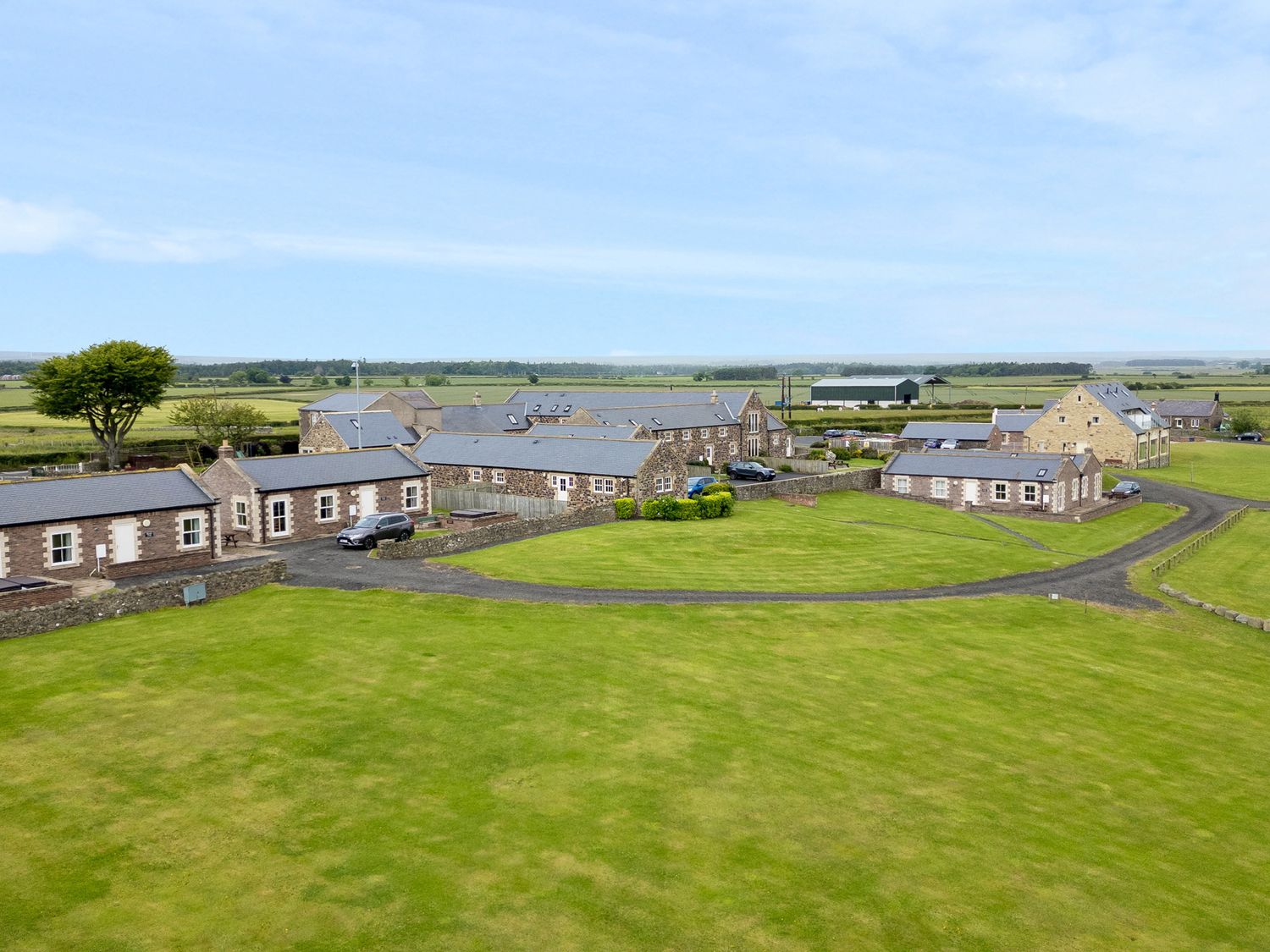 Byre Cottage in Embleton, Northumberland. Single-storey. Child-friendly. Spacious patio with hot tub