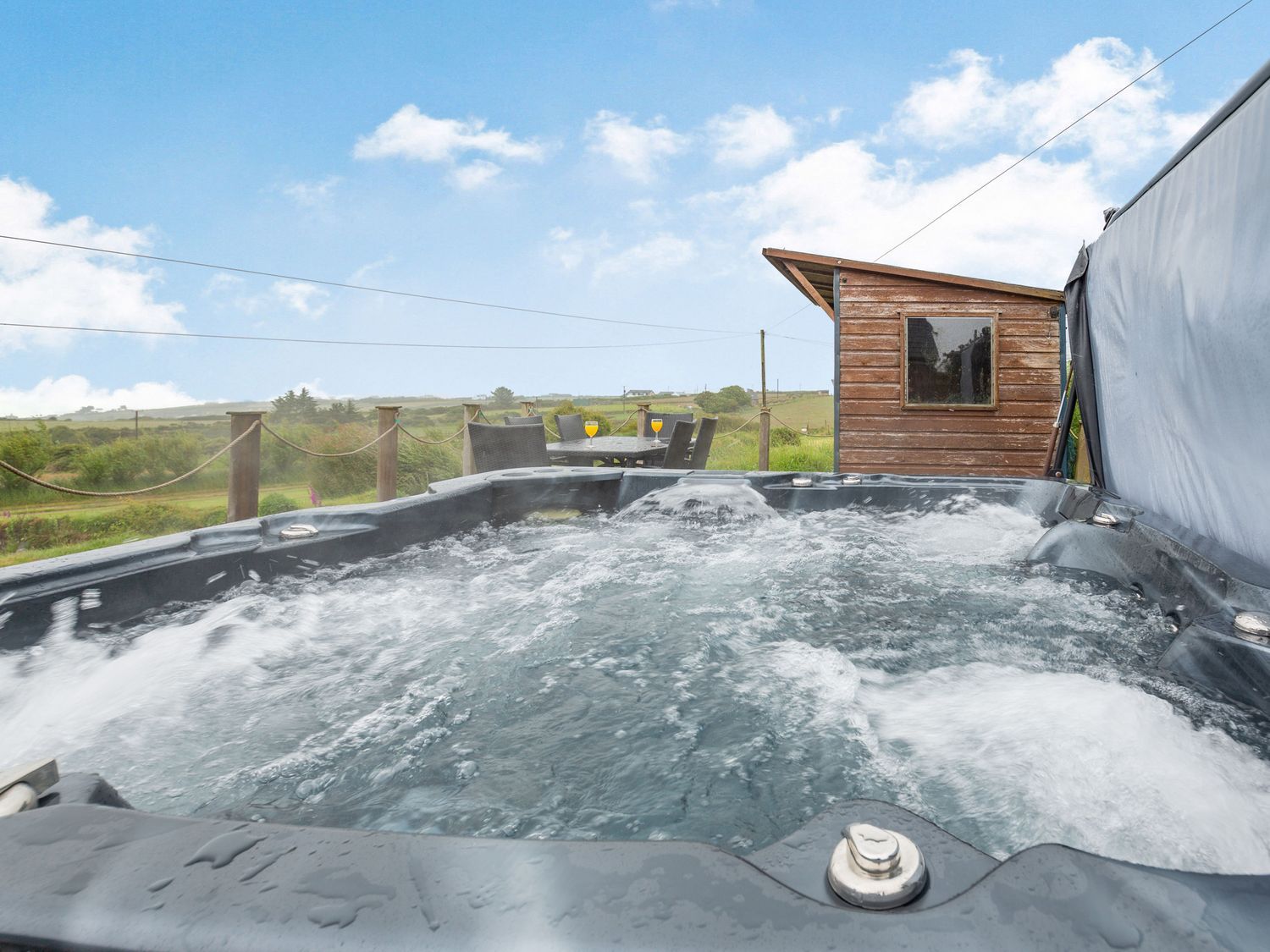 The Farm House near Abersoch, Gwynedd, sleeps seven guests in four bedrooms. Hot tub. Near the beach