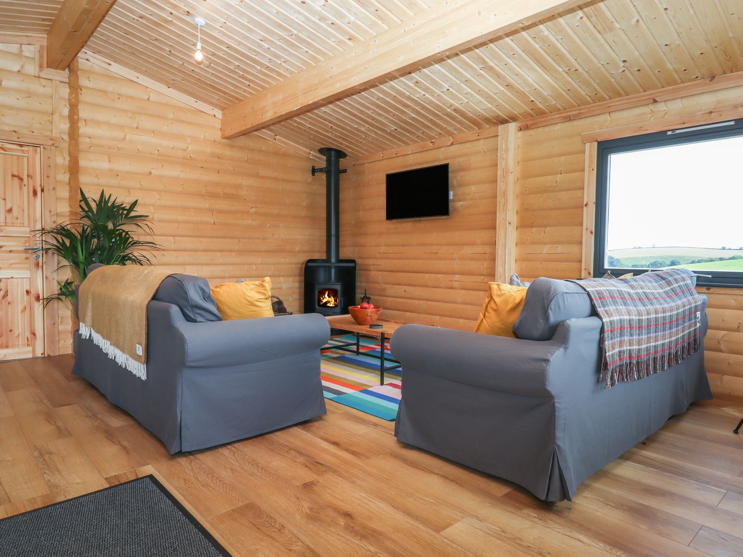 Primrose Lodge in Hittisleigh, Devon. Detached lodge. Open-plan living space with woodburning stove.