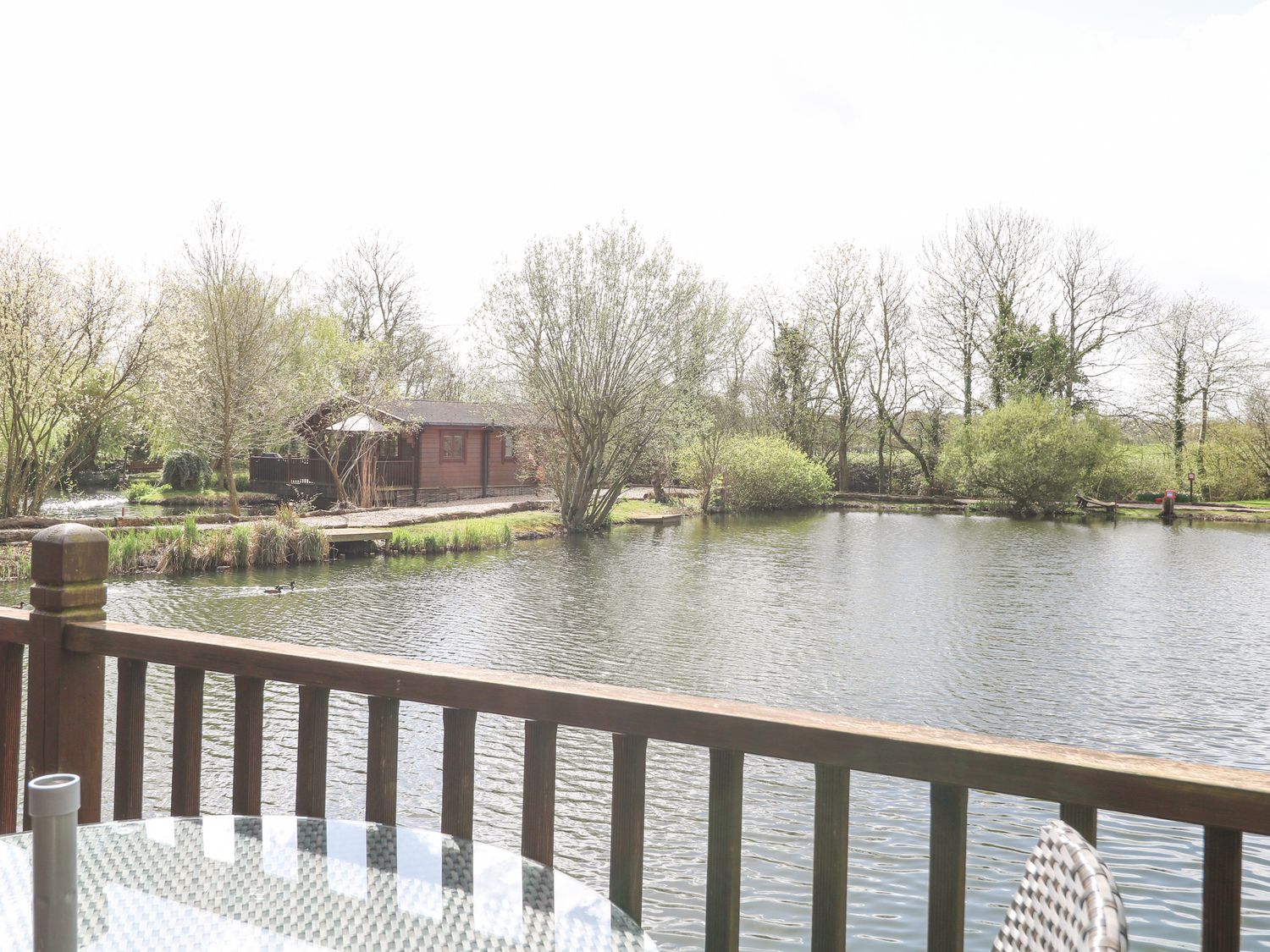 Wagtail Lodge in Badwell Ash in Suffolk. Lakeside lodge. Lovely views. Decking with hot tub and BBQ.