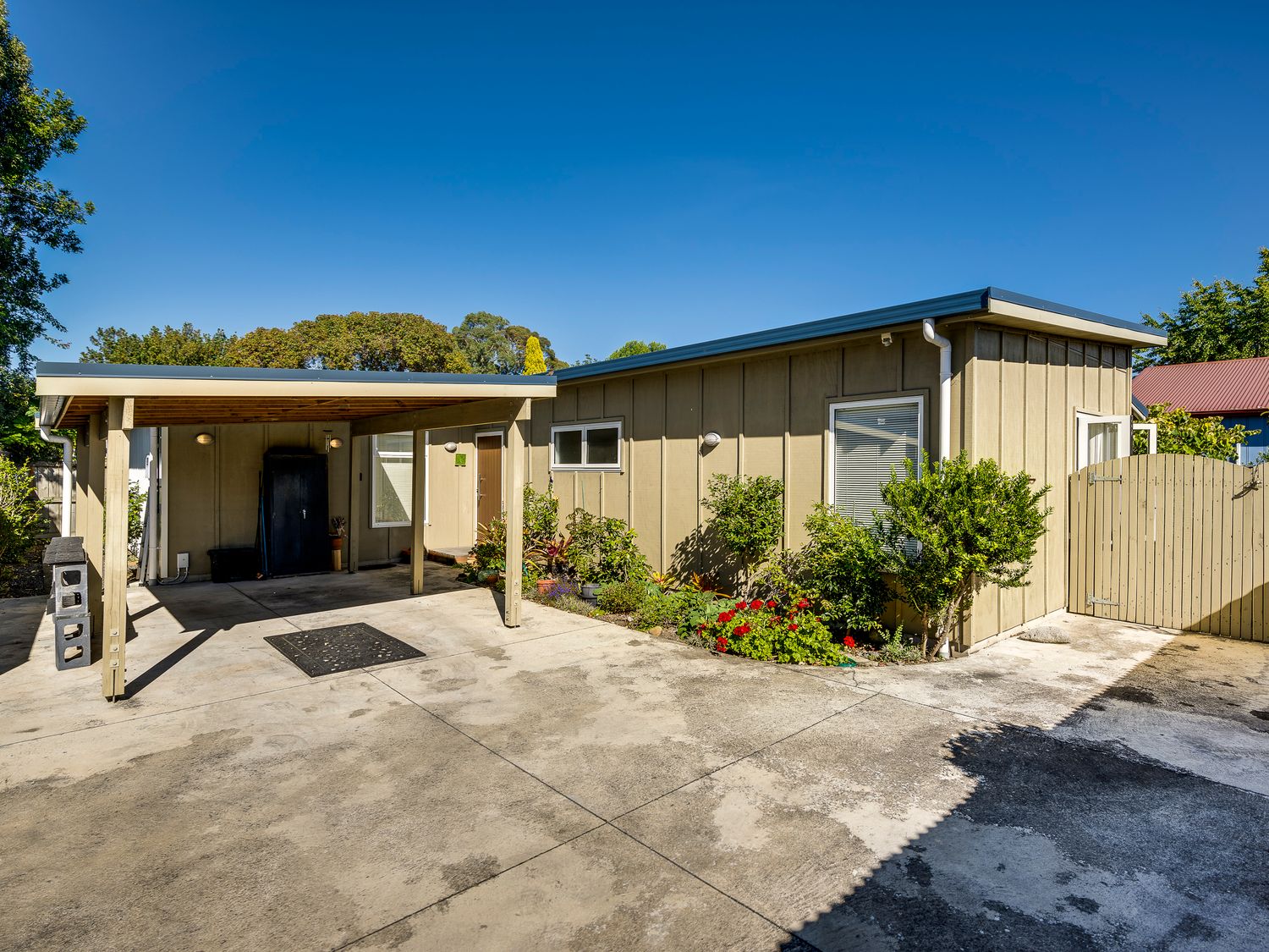 A single story house with carport and plants along the exterior wall at Garden Retreat  Napier Holiday Home