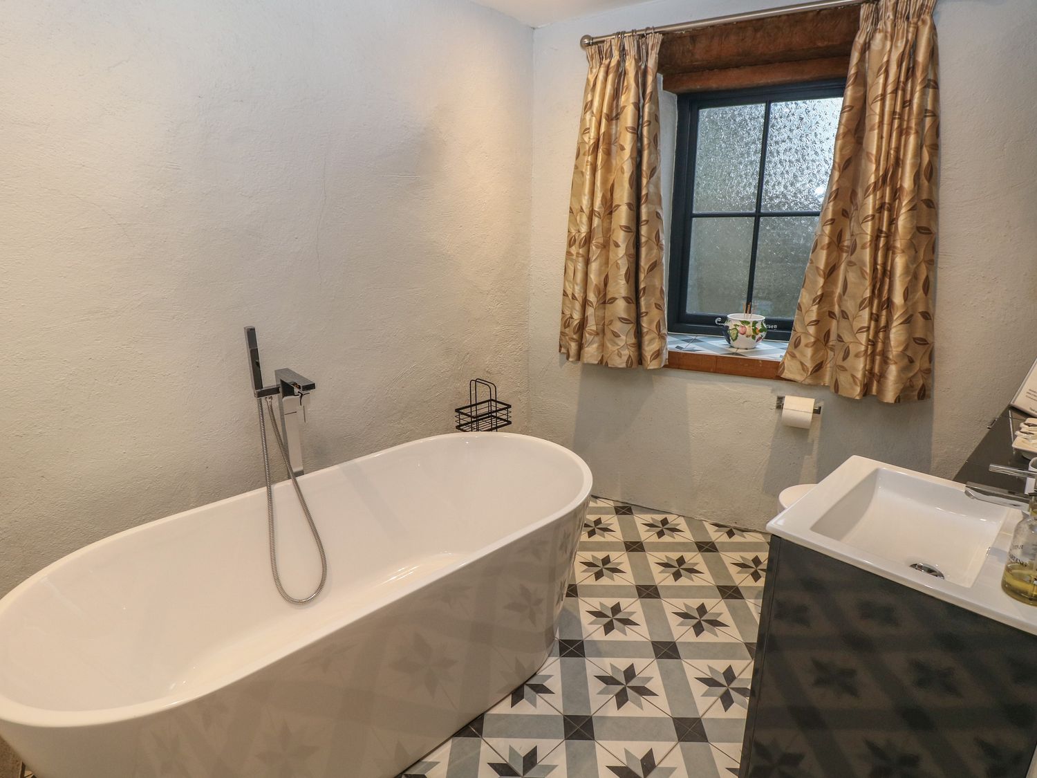 Blacksmiths Cottage rests in Pembrokeshire. Pet-friendly. Hot tub. Cinema room. Woodburning stove.