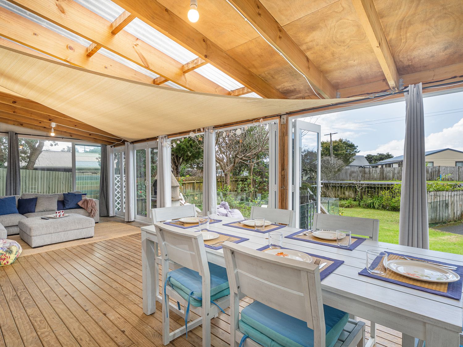 A dining room with a table and chairs at Home Away From Home In Whangamata
