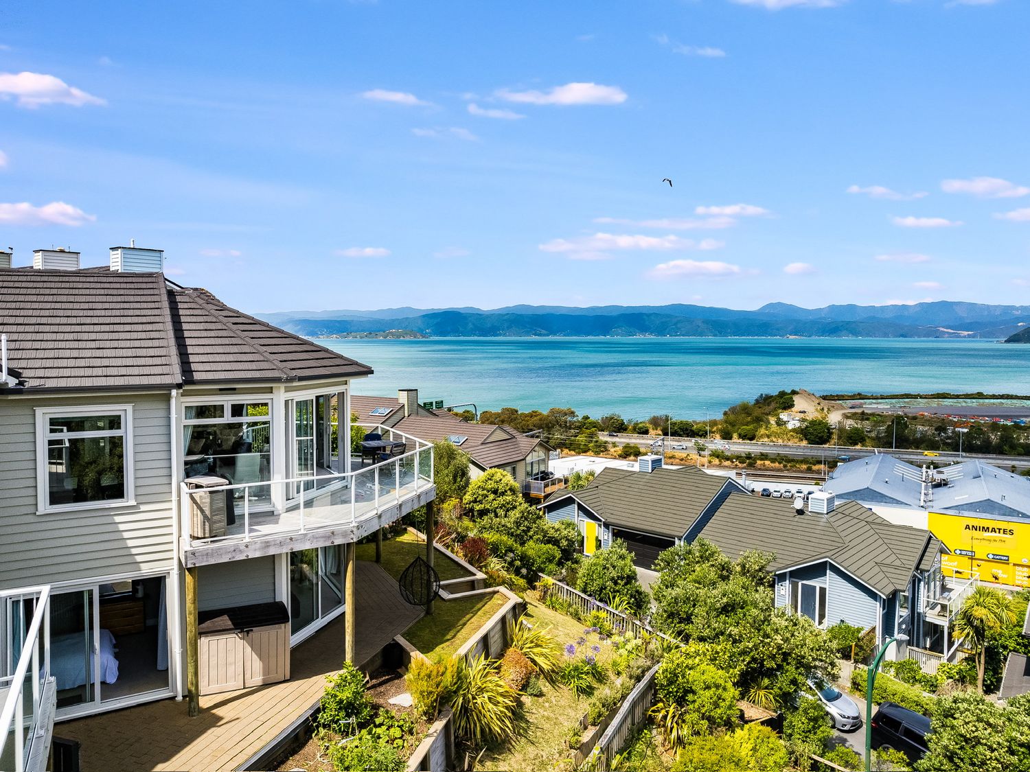 A view of houses and ocean from a balcony at Wellington Holiday in Wellington