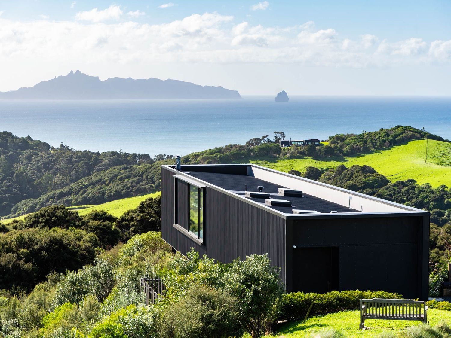 A house with windows overlooking the ocean at Mangawhai Heads Holiday Home Mangawhai
