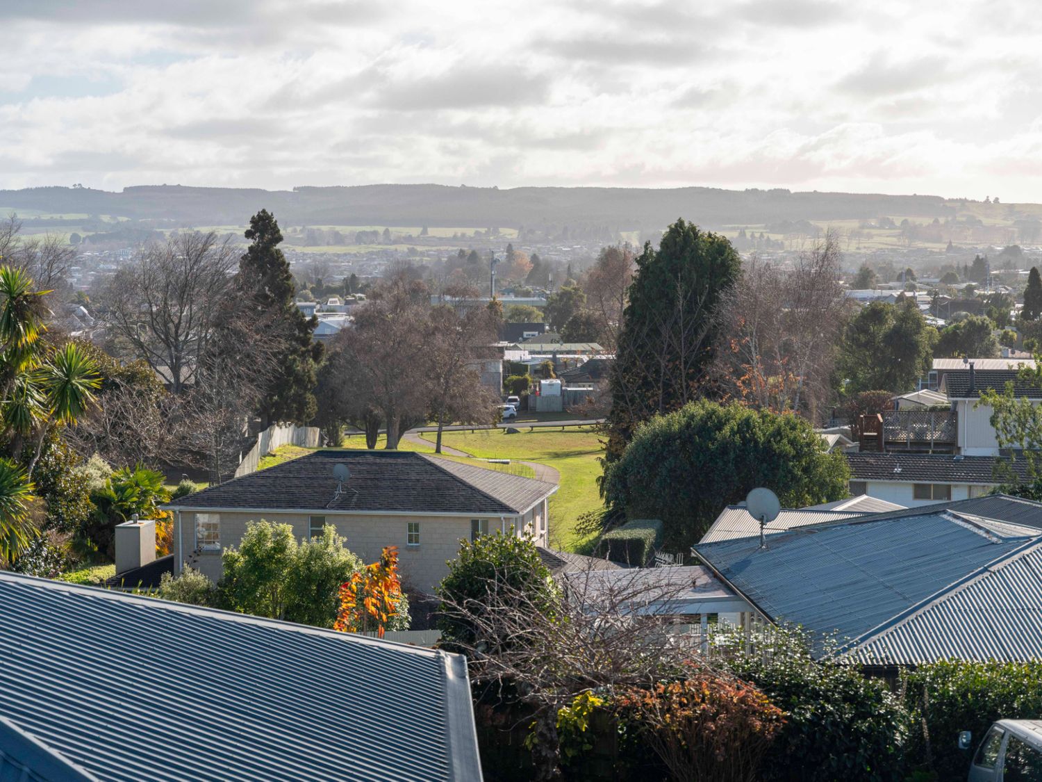 A view of houses and trees with fields in the background at Taupo view road holiday home, Taupo