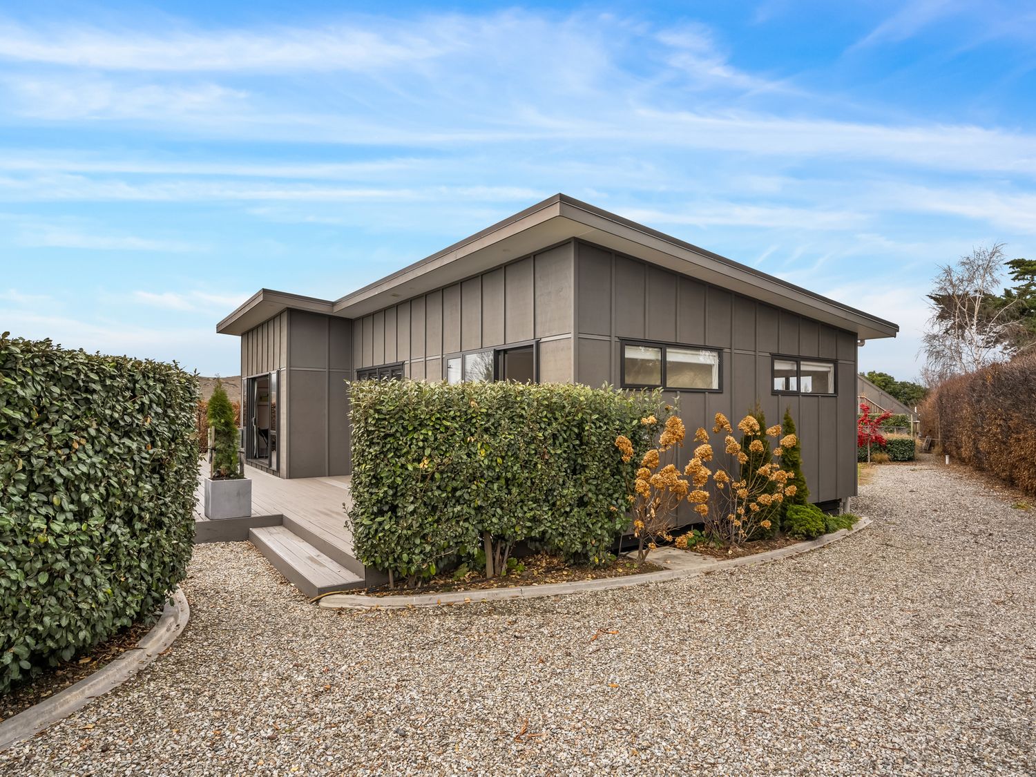 A house with garden and gravel pathway at Vista Haven - Bannockburn Holiday Home Bannockburn