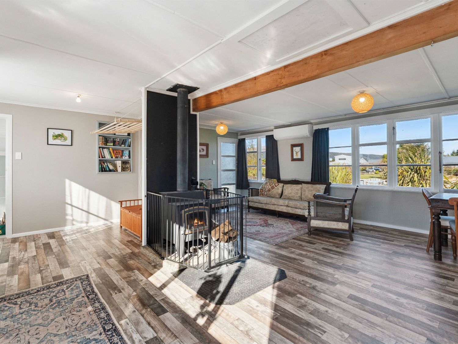 A living room with a fireplace and sofa at The Flax Cottage - National Park Holiday Home
