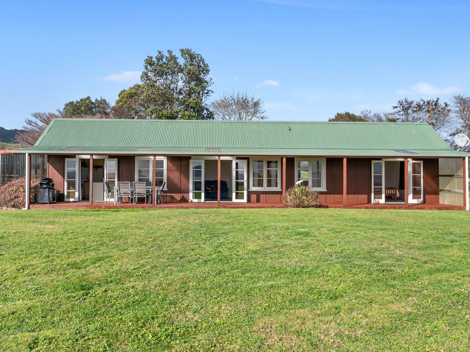 A house with a green roof and deck area at Rotorua, Rotorua