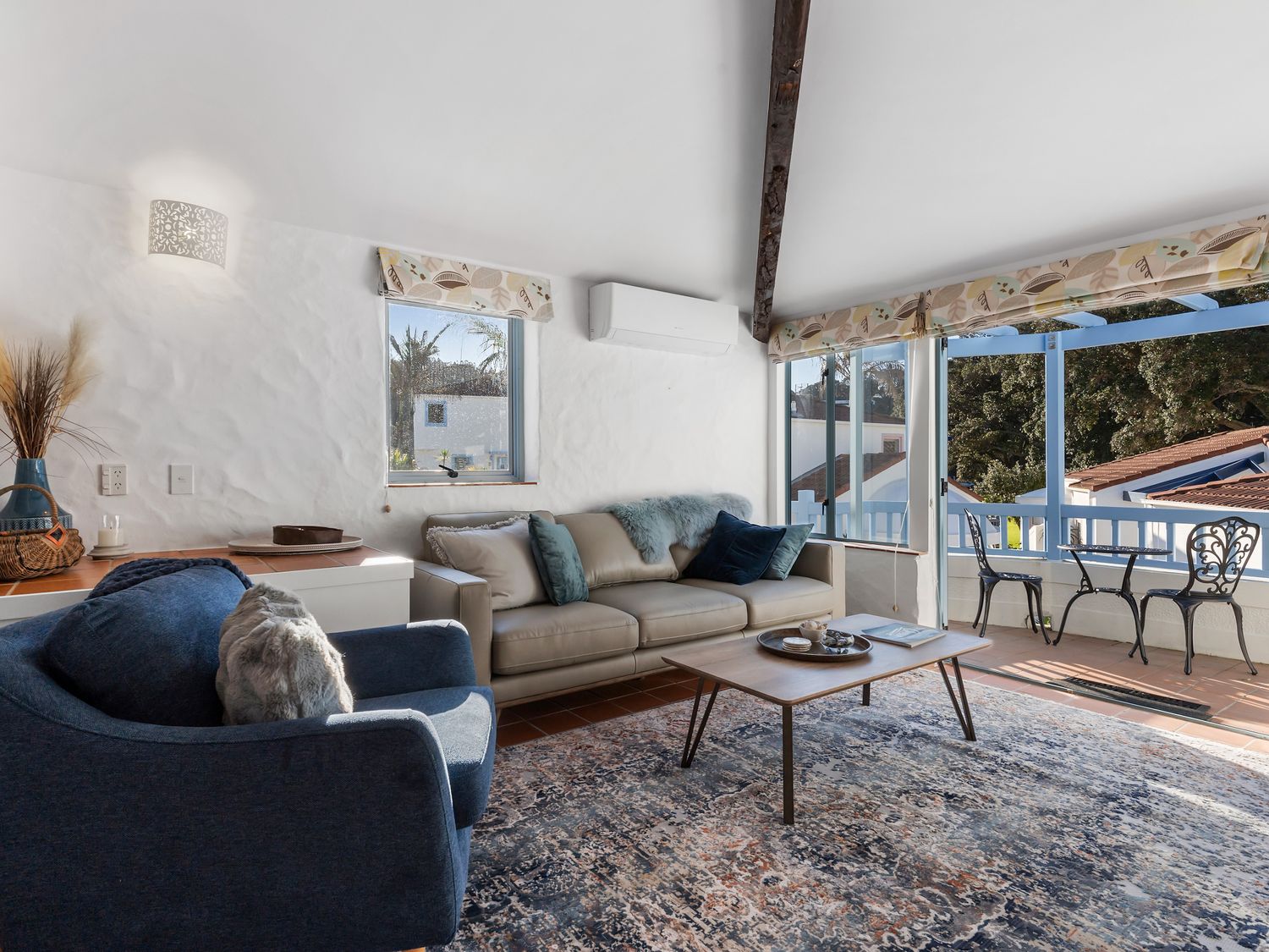 A living room with a sofa and coffee table at Sea Breeze - Orewa Oceanside Apartments in Orewa