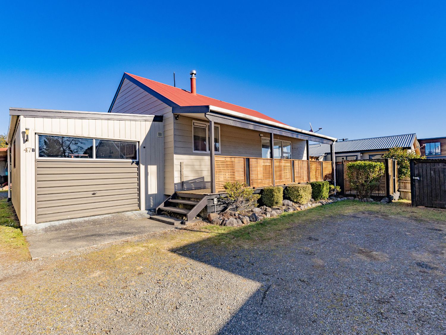 A house with a garage and garden at All Year Round Adventure Base - National Park