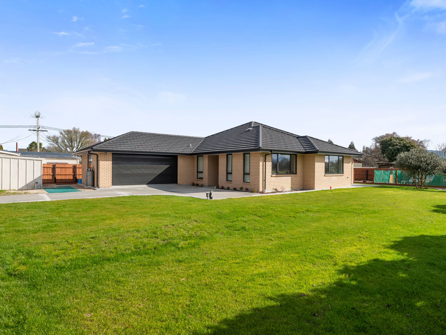 A house with a garage and lawn at Repatoa Holiday Home in Repatoa