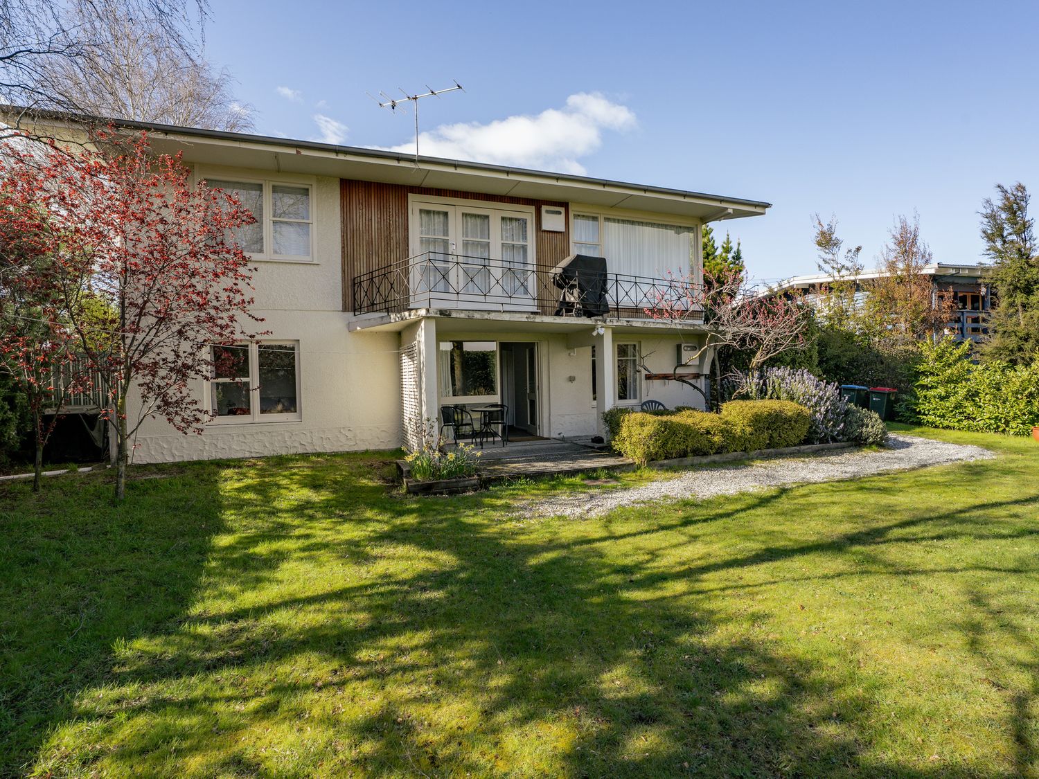 A house with a garden and balcony at Wanaka Holiday Home in Wanaka