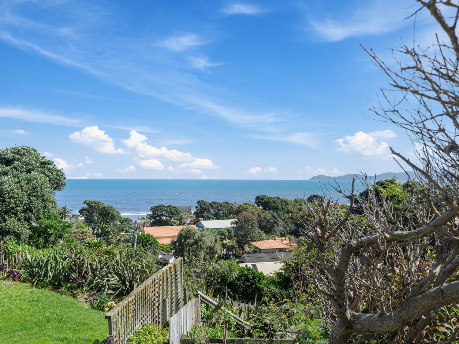 A view of the ocean and sky from a hillside at Ocean Breeze Cottage - Paekakariki Holiday Home