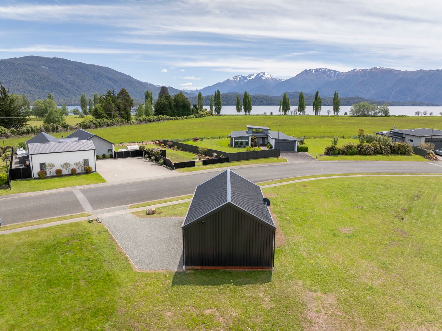 An outdoor view of houses and surrounding landscape at Te Anau Holiday Home Te Anau