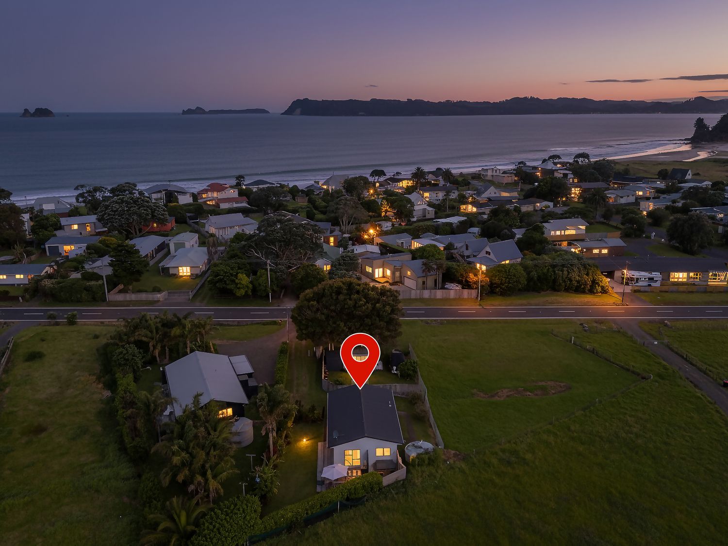 A view of houses near the ocean at Cozy Cottage - Whitianga Holiday Home, Whitianga