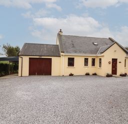 A house with a gravel driveway and attached garage at Silver Birch in Dromelihy Cooraclare County Clare