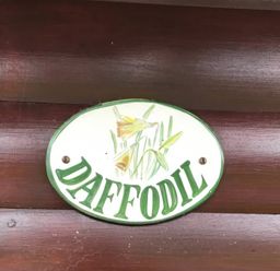 A sign with the word Daffodil and a floral design at Daffodil Lodge in Saltburn-by-the-Sea
