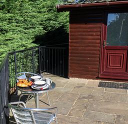 An outdoor patio with a table and chairs at Orchid Lodge in Saltburn-by-the-Sea