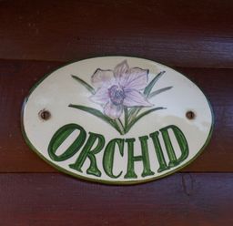 A sign with 'ORCHID' and a flower design at Orchid Lodge Saltburn-by-the-Sea