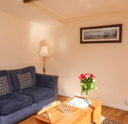 A living room with a sofa, lamp, and coffee table at Orchid Lodge in Saltburn-by-the-Sea