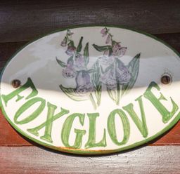 A sign with the word Foxglove and a flower illustration at Foxglove Lodge in Saltburn-By-The-Sea