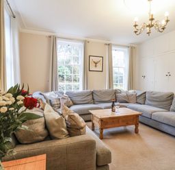 A living room with a sofa and table at The Manor House in Scarborough